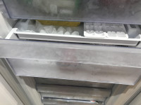 The ice tray when it slides into position on the larger tray , Beko FFP4671W